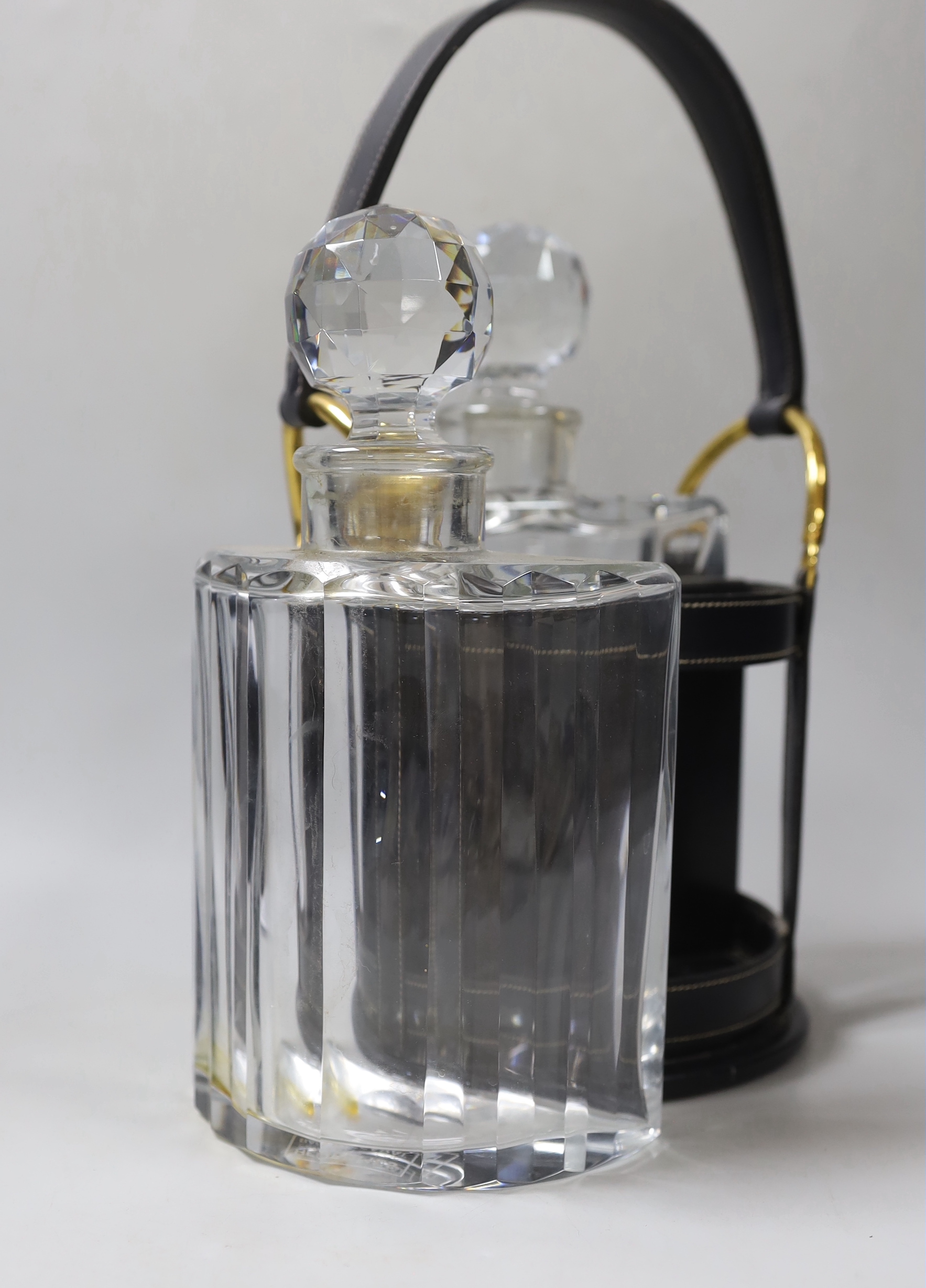 An Hermes black leather decanter set, fitted with two Baccarat glass decanters